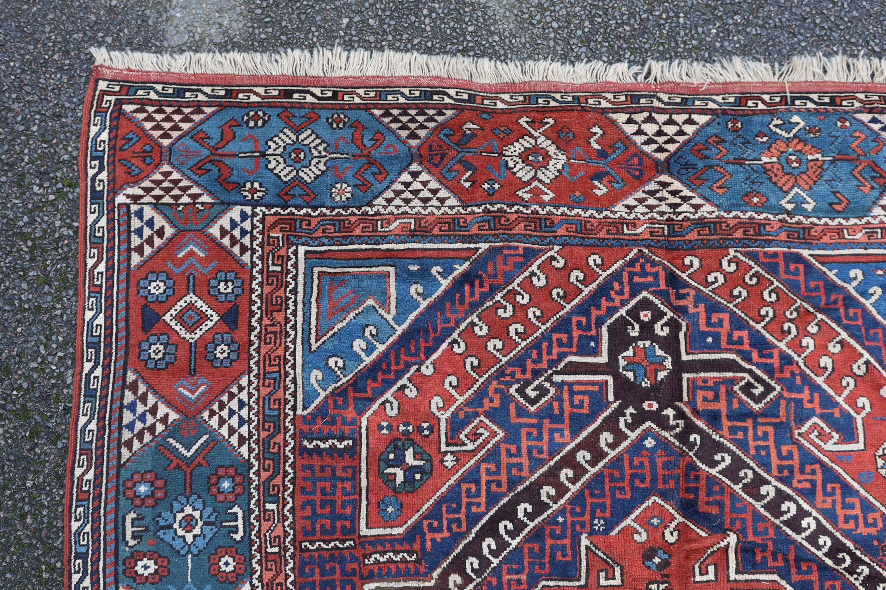 A Bergam Turkish blue ground rug 254 x 198cm